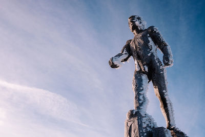 Low angle view of statue against sky