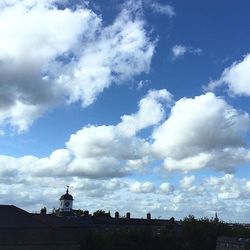 Low angle view of built structure against cloudy sky