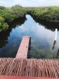 High angle view of wooden pier over lake against sky