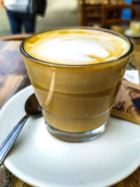 Close-up of cappuccino served on table