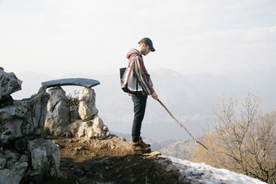 Man standing on rock against mountain
