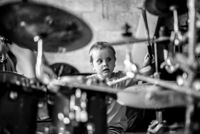 Cute boy playing musical instruments