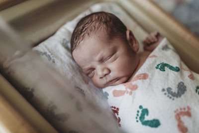 High angle view of baby sleeping in bed