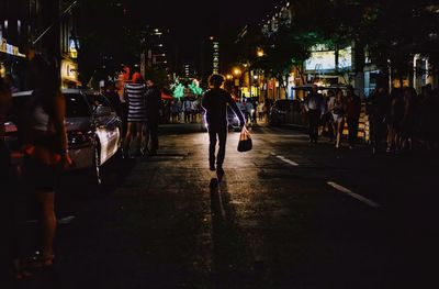 People walking on street at night