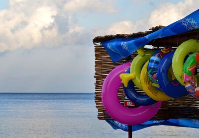 Multi colored umbrella on beach against sky