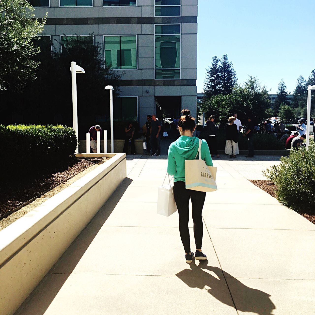 architecture, full length, built structure, shadow, building exterior, walking, lifestyles, sunlight, casual clothing, person, day, outdoors, sky