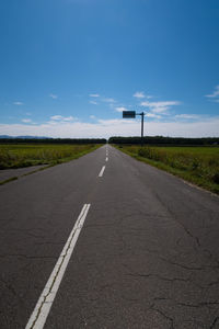 Empty road along countryside landscape