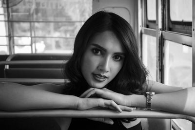 Close-up portrait of young woman sitting in bus