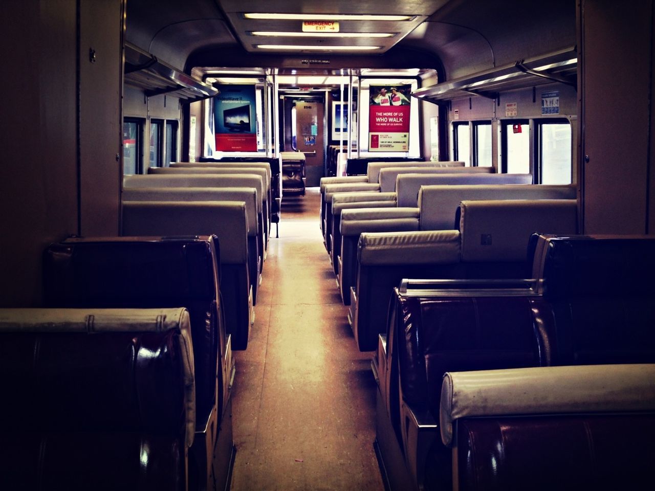 indoors, empty, absence, interior, chair, vehicle seat, seat, in a row, vehicle interior, transportation, illuminated, no people, public transportation, travel, window, diminishing perspective, the way forward, corridor, mode of transport, built structure