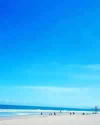 Scenic view of beach against blue sky
