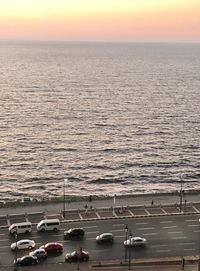 High angle view of sailboats in sea at sunset