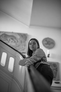 Portrait of young woman on staircase