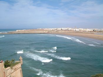 Scenic view of sea against cloudy sky