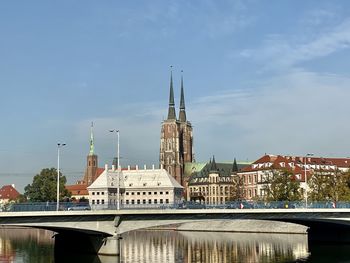 View of buildings by the river against the sky 