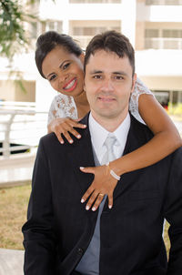 Portrait of smiling bride and groom embracing