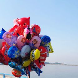 Low angle view of balloons toy against sky