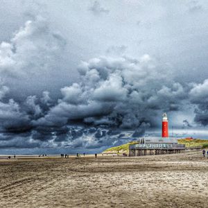 Lighthouse against cloudy sky