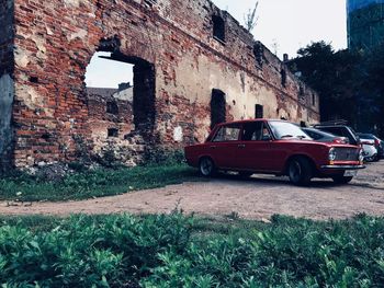 Car on old building in city