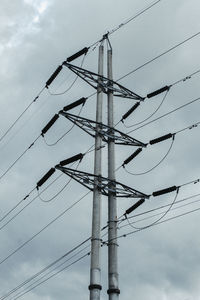 Low angle view of electricity pylon against sky