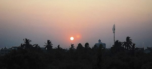 Silhouette trees against sky during sunset