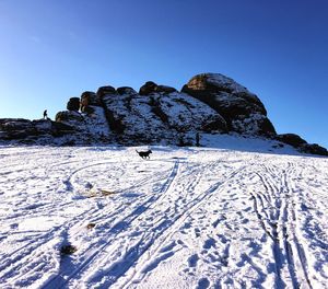 Scenic view of snowcapped mountains against clear blue sky