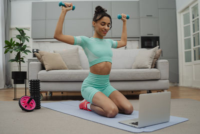 Young woman exercising in gym