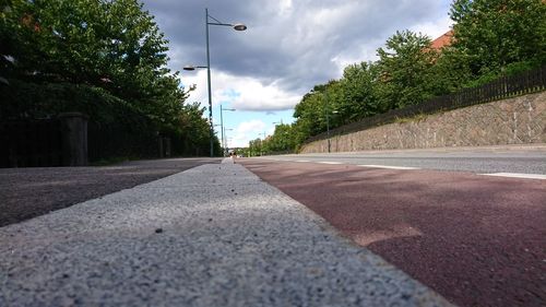 Road amidst trees against sky