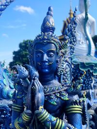 Close-up of buddha statue against building