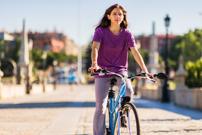 Portrait of woman riding bicycle on street
