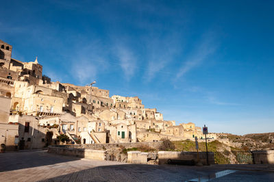 Buildings in city against blue sky