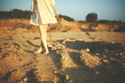 Low section of woman standing on beach