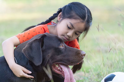 Woman with dog on field