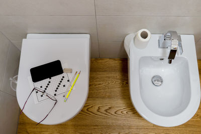  white toilet bowl and bidet equipped with the classic kit for spending time in the bathroom