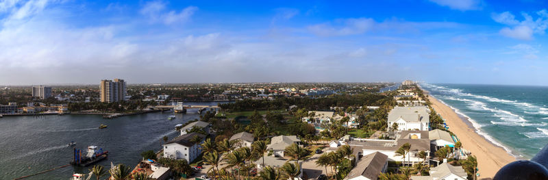 High angle view of buildings and sea against sky