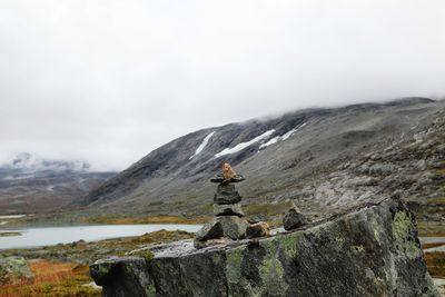 Rock stacking against sky