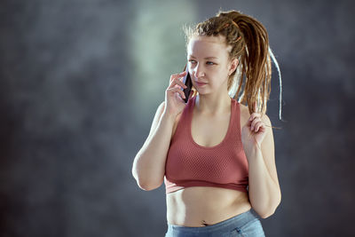 Young woman talking on phone while looking away