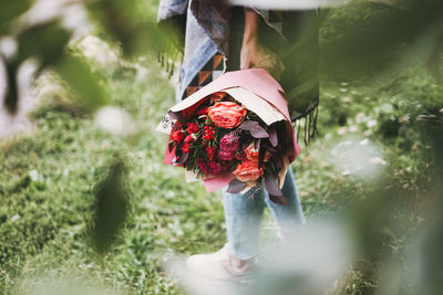 Young woman with bouquet of flowers 