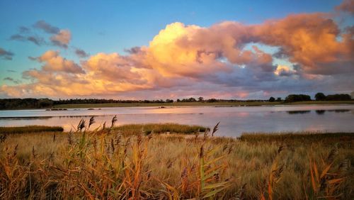 Scenic view of lake against sky during sunset