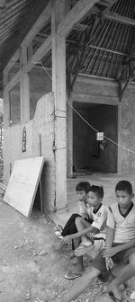 People sitting in corridor of building