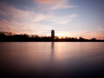 Scenic view of lake against sky during sunset