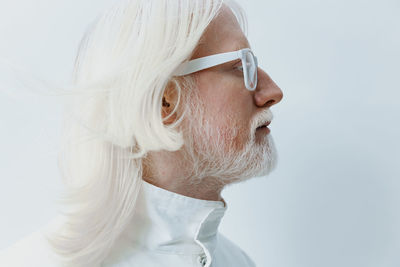 Close-up of young woman against white background