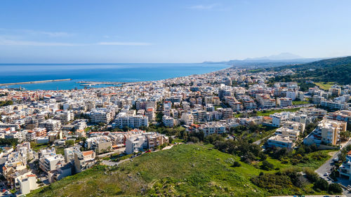 High angle view of townscape by sea against sky