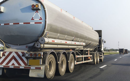 Close-up of truck on road against sky