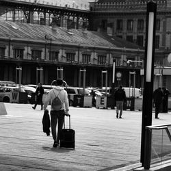 Rear view of woman standing in city