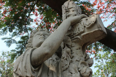 Low angle view of statue against trees