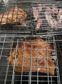 High angle view of meat on barbecue grill