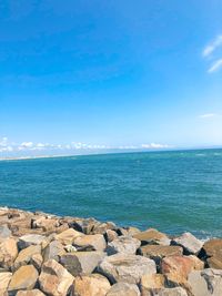 Scenic view of sea against blue sky