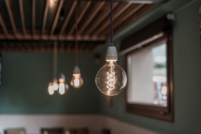 Illuminated light bulbs hanging in store