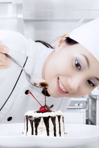 Close-up of female chef preparing dessert in kitchen