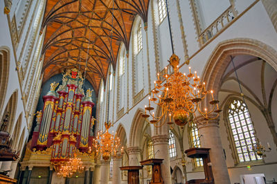 Low angle view of illuminated chandelier in building